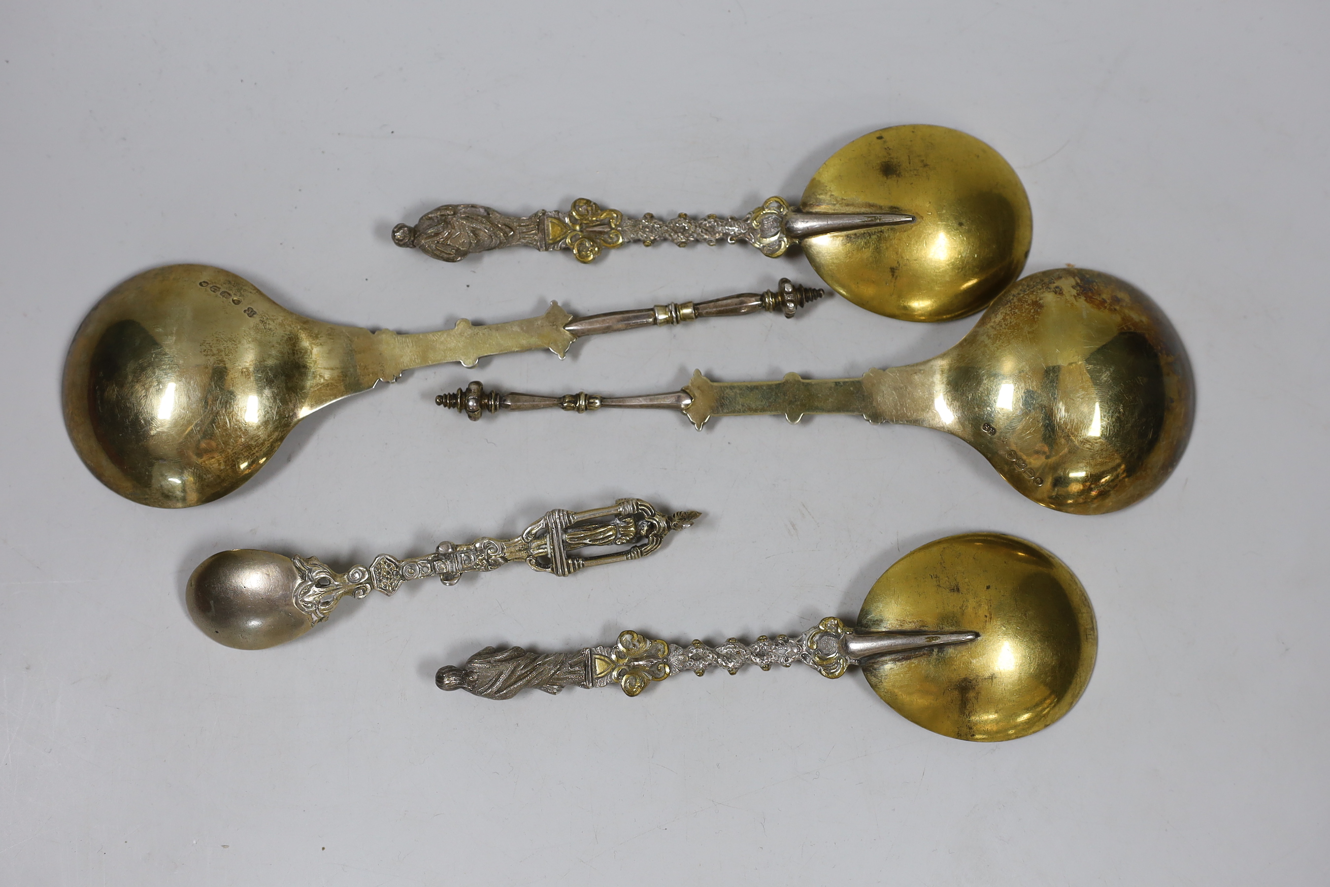 Two Victorian parcel gilt silver apostle spoons, London, 1879 and 1882, 20.2cm, 4.5oz and three other spoons.